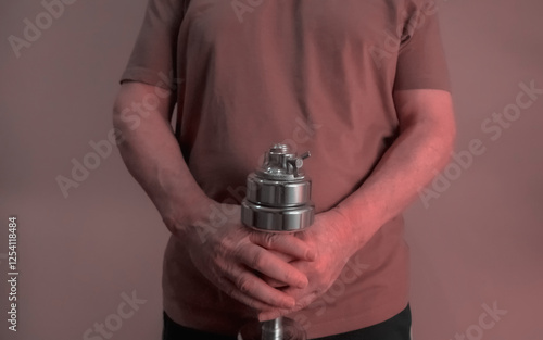 Obraz na płótnie Senior man holding adjustable dumbbell horizontally, fitness and health in old age w salonie
