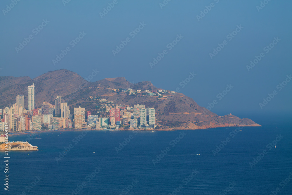 Fototapeta premium Coastal City Skyline with Mountains and Sea