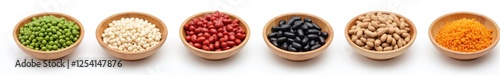 Collection of legumes in wooden bowls isolated on white background. Healthy food ingredients peas, soy, black beans, peanuts, lentils. Close-up of diet vegetarian organic grains.