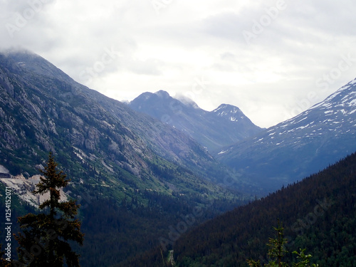 Snow-Capped Mountain Peaks and Verdant Valleys in Skagway, Alask photo