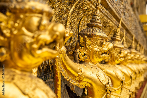 Canvas Print Golden Garuda statues adorning the exterior walls of Wat Phra Kaew, Temple of the Emerald Buddha, the most sacred Buddhist temple in Bangkok, Thailand