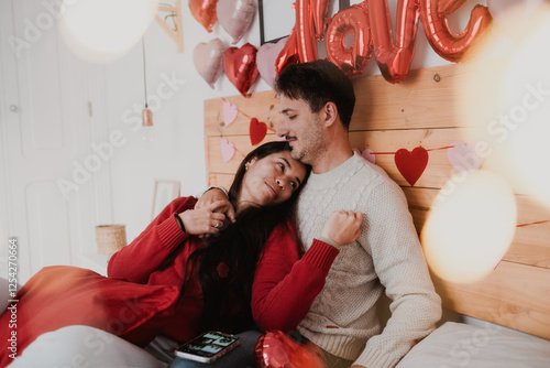 Romantic Couple on Valentine’s Day with Petals and Pet in Bedroom