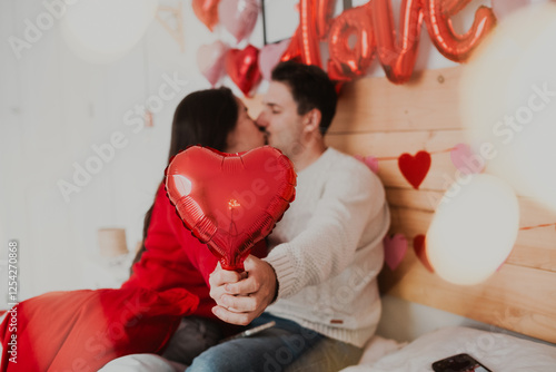 Romantic Couple on Valentine’s Day with Petals and Pet in Bedroom