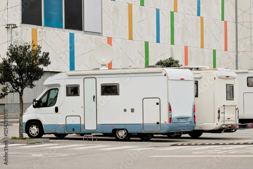 Modern Camper Vans Parked Near a Contemporary Shopping Mall Center Building