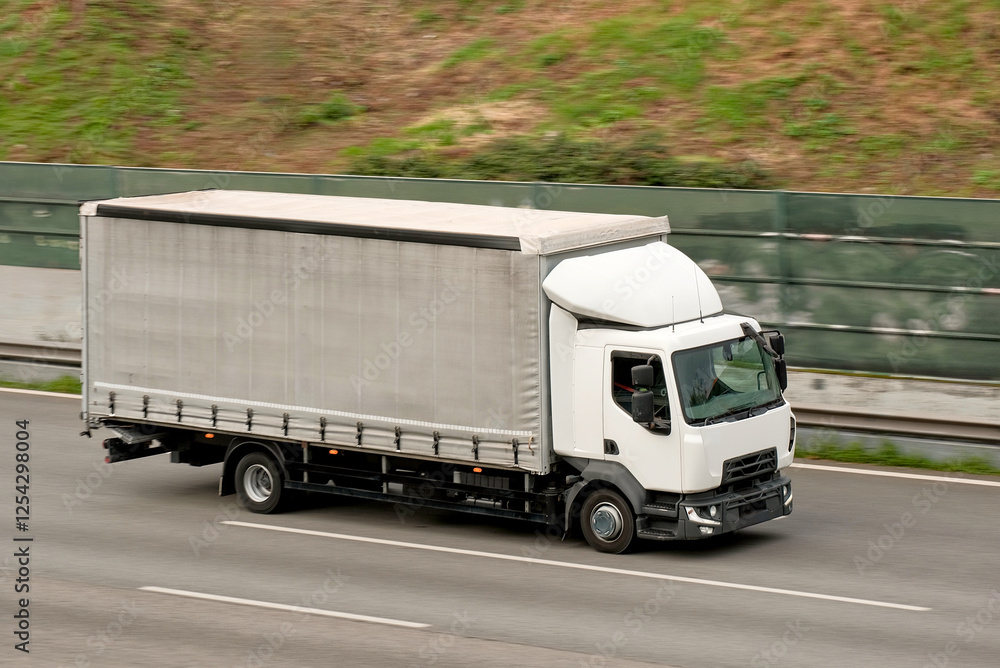 Compact Lightweight Cargo Goods Transporter Truck In Motion Compact Lightweight Cargo Goods Transporter Truck In Motion