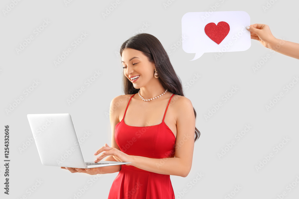 Happy young woman video chatting with boyfriend on light background. Online dating Happy young woman video chatting with boyfriend on light background. Online dating