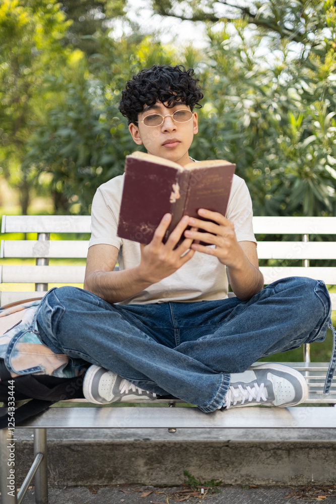 Enjoying a peaceful moment reading a book while sitting cross-legged, perfect for themes like relaxation, reading, and cozy moments. Enjoying a peaceful moment reading a book while sitting cross-legged, perfect for themes like relaxation, reading, and cozy moments.