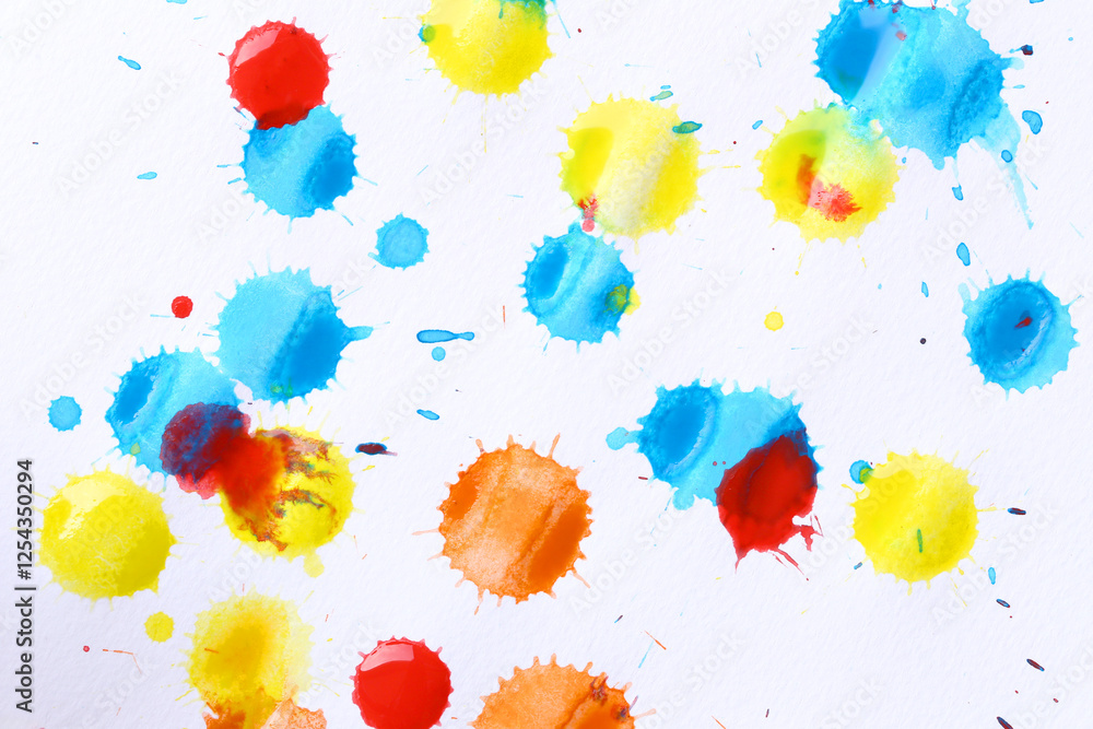 Various color paint drops on paper, causing dispersion of color.