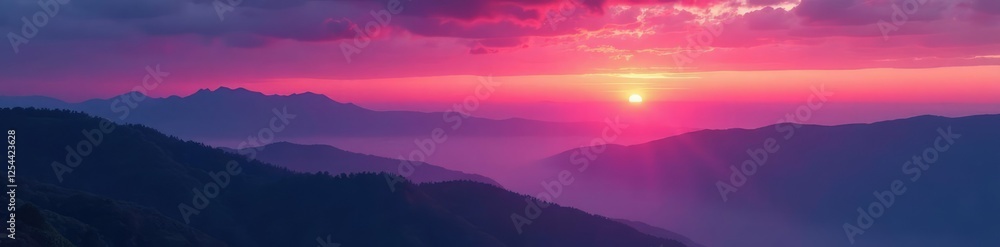 Fototapeta premium Rich plum-colored sunset over a misty mountain range, valley, clouds, nature