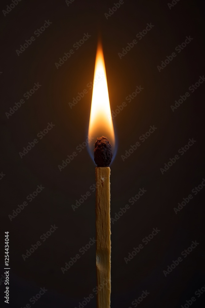 Burning matchstick with glowing flame in dark background Burning matchstick with glowing flame in dark background