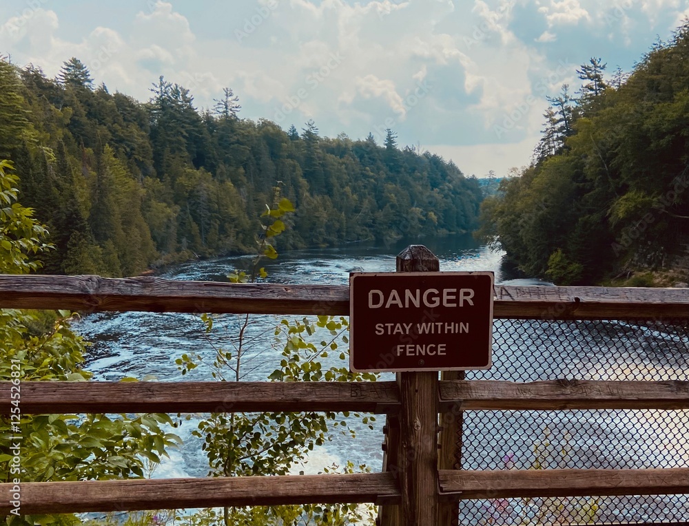 Fototapeta premium hiking trail sign near waterfall