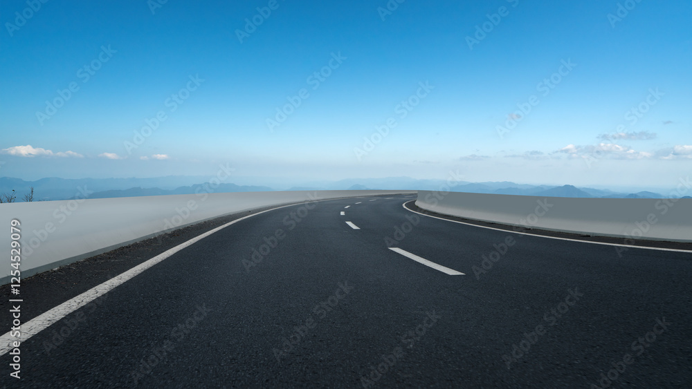 Scenic Curved Road with Open Sky and Mountains in the Background Scenic Curved Road with Open Sky and Mountains in the Background