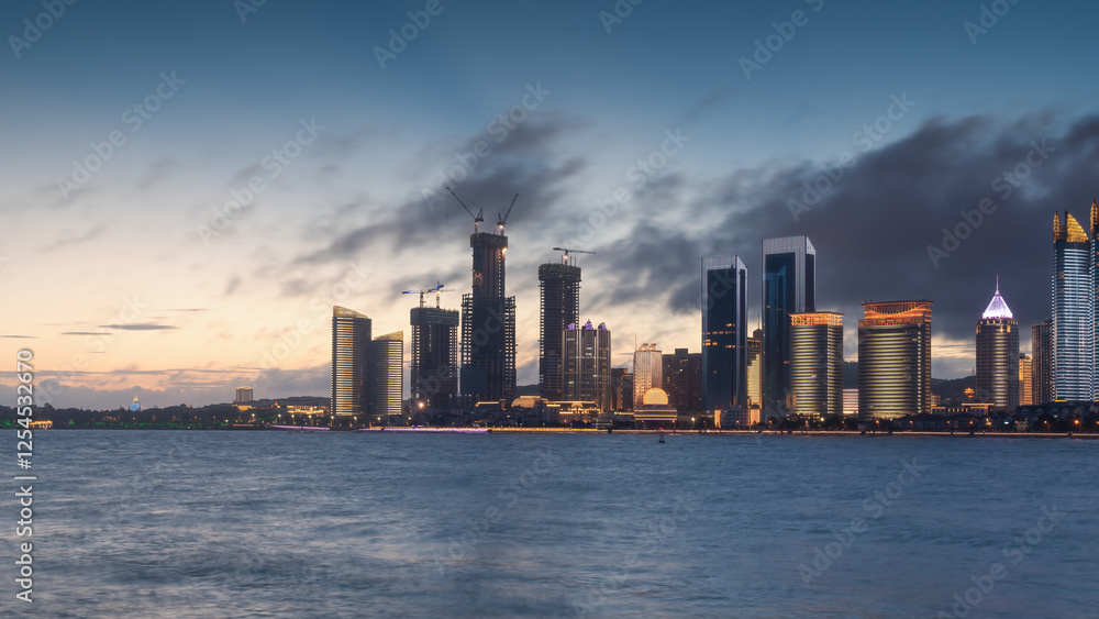 Fototapeta premium Serene Cityscape at Dusk with Modern Architecture and Reflective Waters