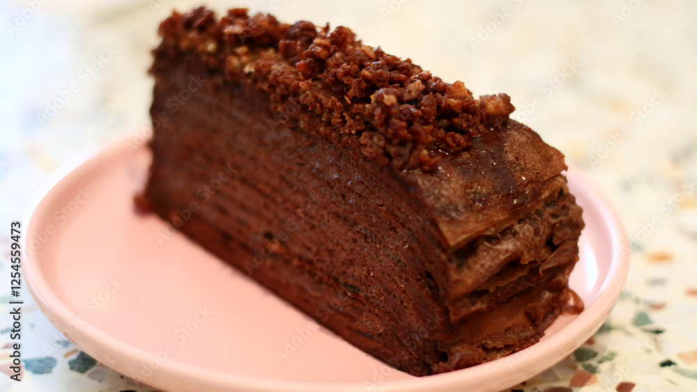 Chocolate mille crepes. A cake consisting of layers of stacked crepes with a cream filling. Chocolate mille crepes. A cake consisting of layers of stacked crepes with a cream filling.