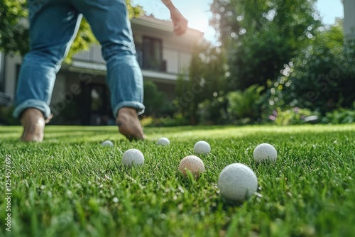 Outdoor leisure activity involving golf balls on a sunny day in a backyard