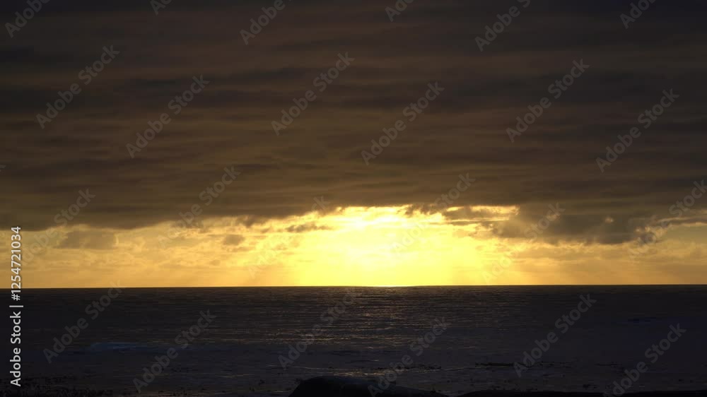 Golden sun rays over a dark sea Golden sun rays over a dark sea