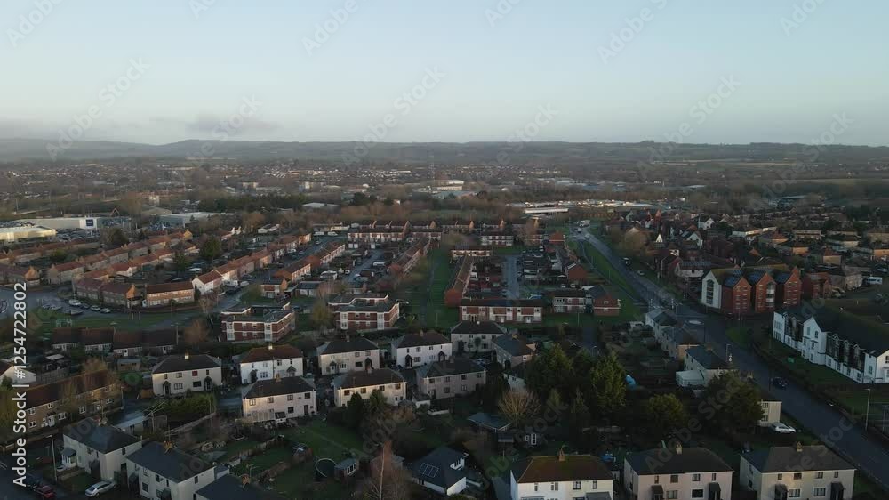 Aerial view of the Taunton in the United Kingdom after a rainy night. View of the residential estates. Drone moving backwards and rotating to the left showing most of the town. Aerial view of the Taunton in the United Kingdom after a rainy night. View of the residential estates. Drone moving backwards and rotating to the left showing most of the town.