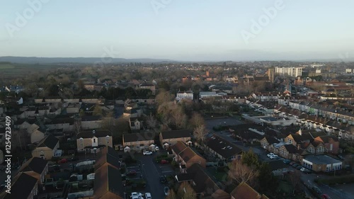 Wallpaper Mural Aerial view of the Taunton in the United Kingdom after a rainy night. Roof top view of the residential estates. Drone moving forward over the houses and streets. Some threes between the buildings. Torontodigital.ca