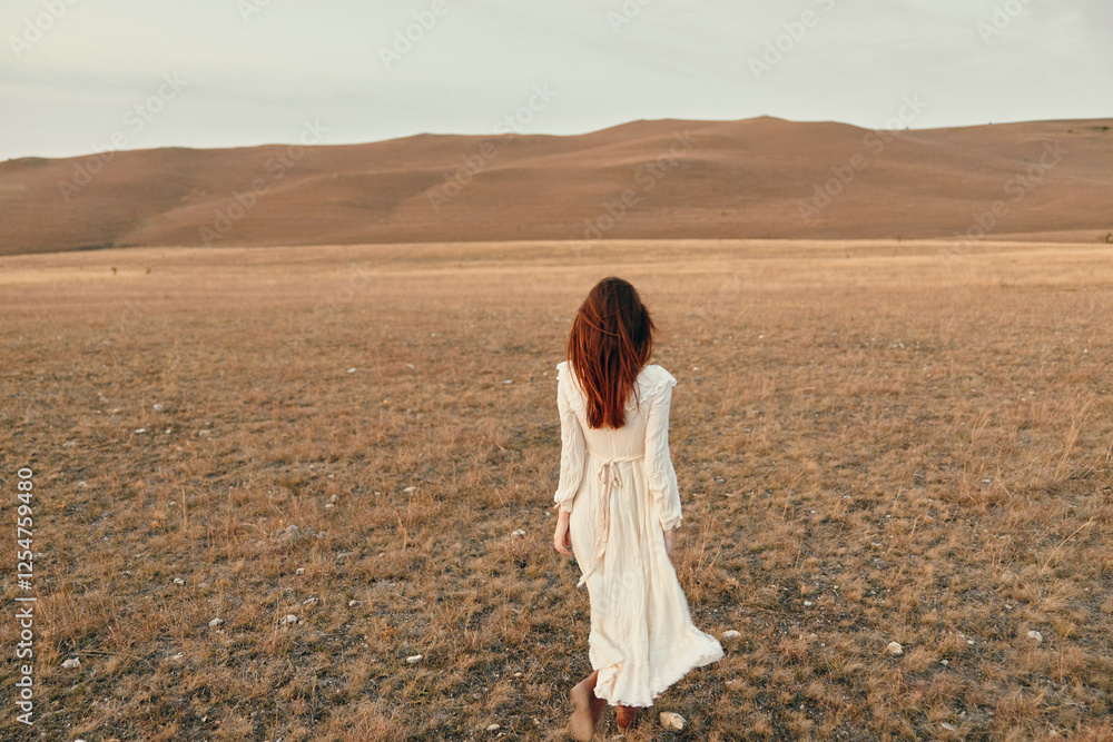Woman standing in white dress in open field with mountains in background, travel beauty serenity nature landscapetripdestination Woman standing in white dress in open field with mountains in background, travel beauty serenity nature landscapetripdestination