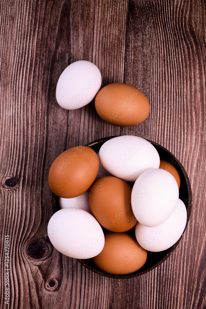 brown chicken eggs in a bowl on a wooden surface brown chicken eggs in a bowl on a wooden surface