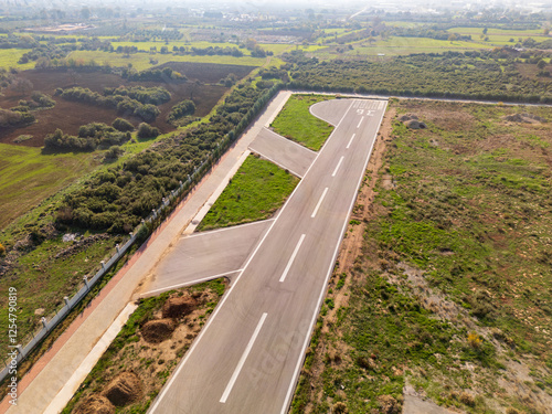 Photography Aerial view of small airstrip in rural area at sunset