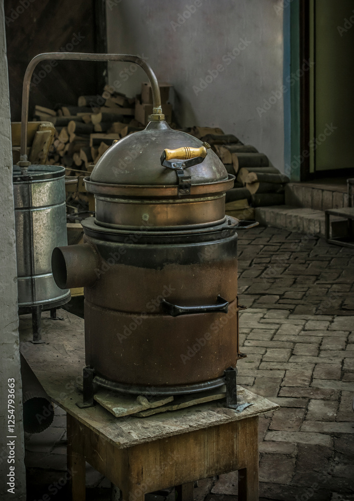An old brandy cauldron, brewing equipment in the countryside An old brandy cauldron, brewing equipment in the countryside