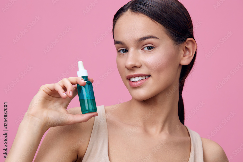Young woman with flawless skin holding a green serum bottle against a pink background, embodying beauty and skincare concepts in a fresh and vibrant style Young woman with flawless skin holding a green serum bottle against a pink background, embodying beauty and skincare concepts in a fresh and vibrant style