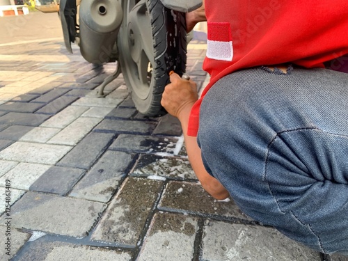 a man who was repairing a punctured motorbike tire