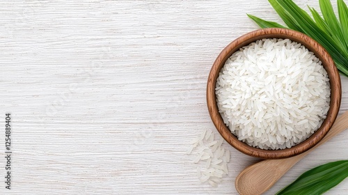 Obraz na płótnie Cooked rice in bowl, wooden spoon, leaves. Food photography, website banner w salonie