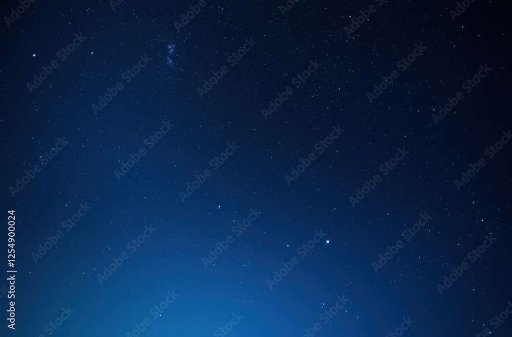 Fototapeta premium Starry Night Sky Illuminated by a Gentle Blue Glow Over a Quiet Landscape 