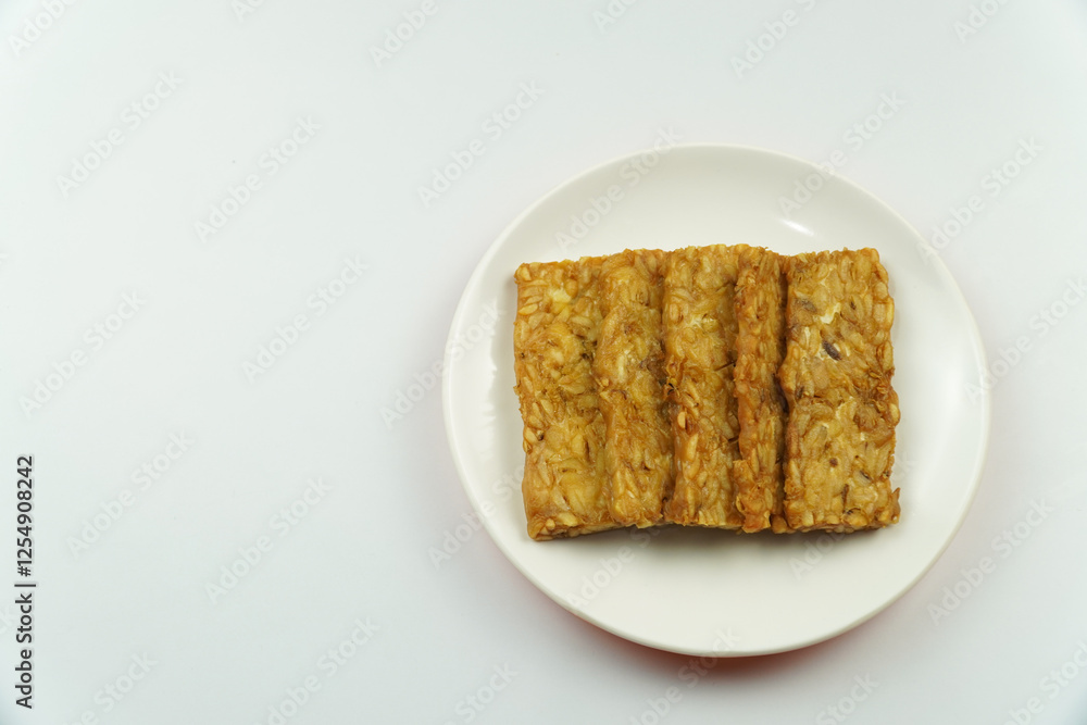 Plate of Fried Tempeh Slices, Indonesian Traditional Food Isolated on white background Plate of Fried Tempeh Slices, Indonesian Traditional Food Isolated on white background