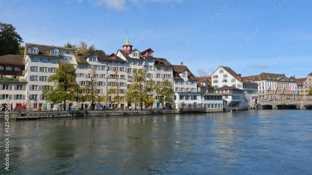 City skyline of Zurich in Switzerland. Old Town at Limmat River with Rudolf-Brun-Brücke bridge, panning to the left.