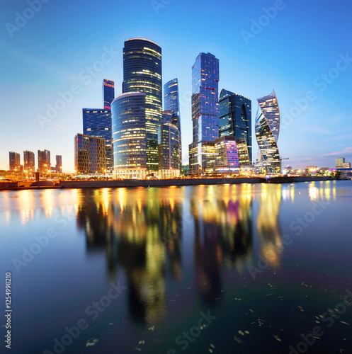 Skyscrapers of Moscow City business center and Moscow river in Moscow at night, Russia. Architecture and landmark of Moscow