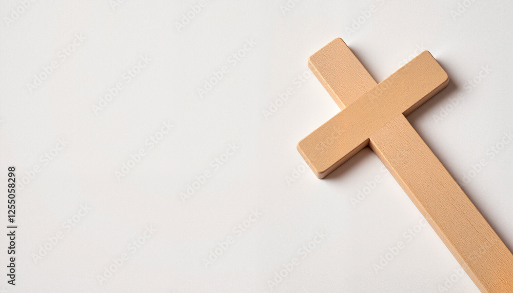 Obraz premium Minimalistic wooden cross on clean white background symbolizing faith and devotion