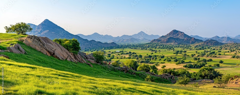 Obraz premium Lush green hills under a clear blue sky.
