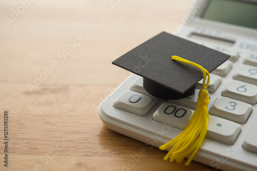 Mortarboard on calculator. Money financial management and planning for education, student debt or loan, repayment, budget cost calculate home, finance concept. Education is investment for future. photo