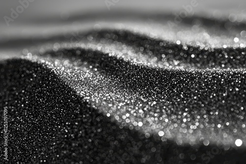 Close-up of Shimmering Dark Sand with Tiny Particles photo