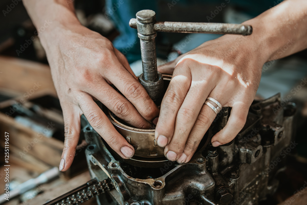 Motorcycle Engine Rebuild, Motorcycle mechanic repairing Engine and use Pulsar magnet puller,working at garage, maintenance and repair motorcycle concept