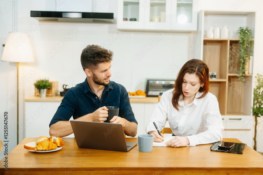 Modern couple collaborating over coffee in a cozy kitchen setting with a laptop, notebook, and breakfast. Modern couple collaborating over coffee in a cozy kitchen setting with a laptop, notebook, and breakfast.