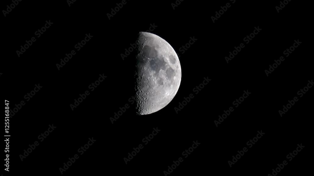 Illuminated surface of half moon travelling slowly across dark night sky in outer space Illuminated surface of half moon travelling slowly across dark night sky in outer space