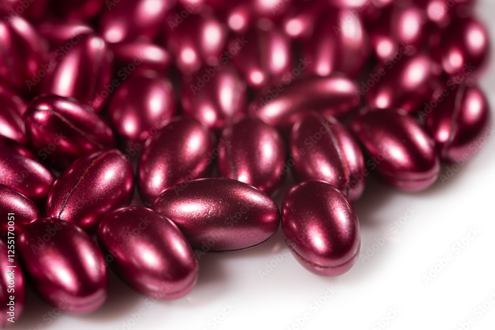 red softgels capsules of vitamins on white background red softgels capsules of vitamins on white background