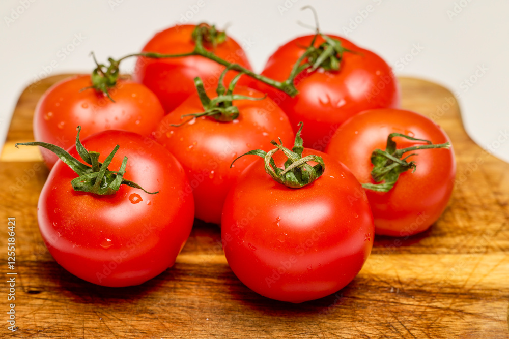 fresh tomatoes on a wooden chopping board fresh tomatoes on a wooden chopping board