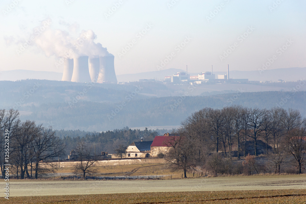 A farmhouse in southern Czechia and the Temelin Nuclear Power Plant on the horizon. Cold winter morning.