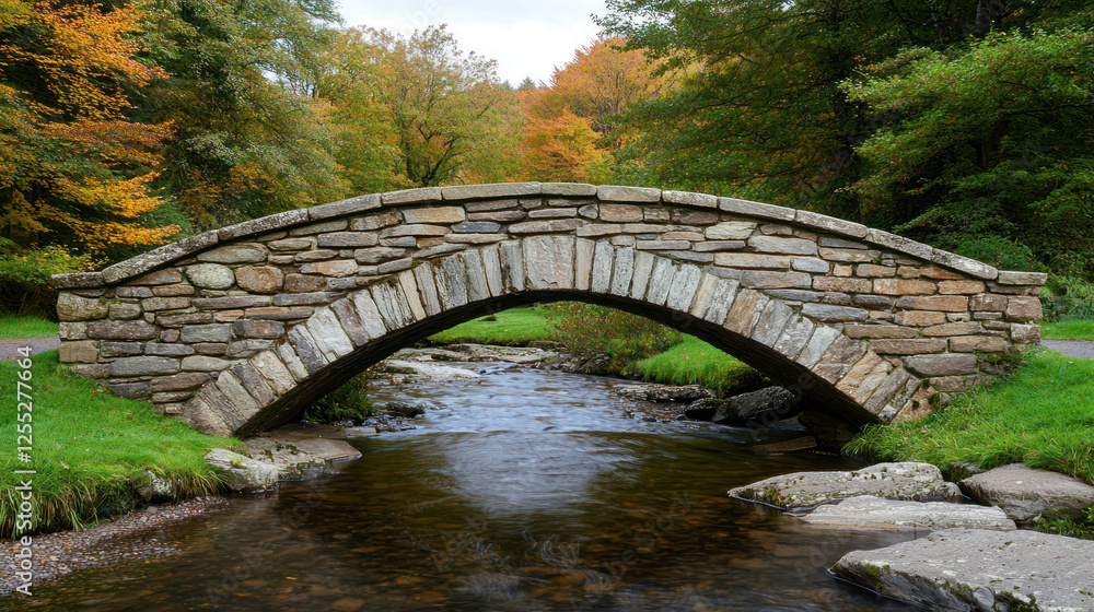 picturesque stone bridge arches over serene stream surrounded by vibrant autumn foliage picturesque stone bridge arches over serene stream surrounded by vibrant autumn foliage