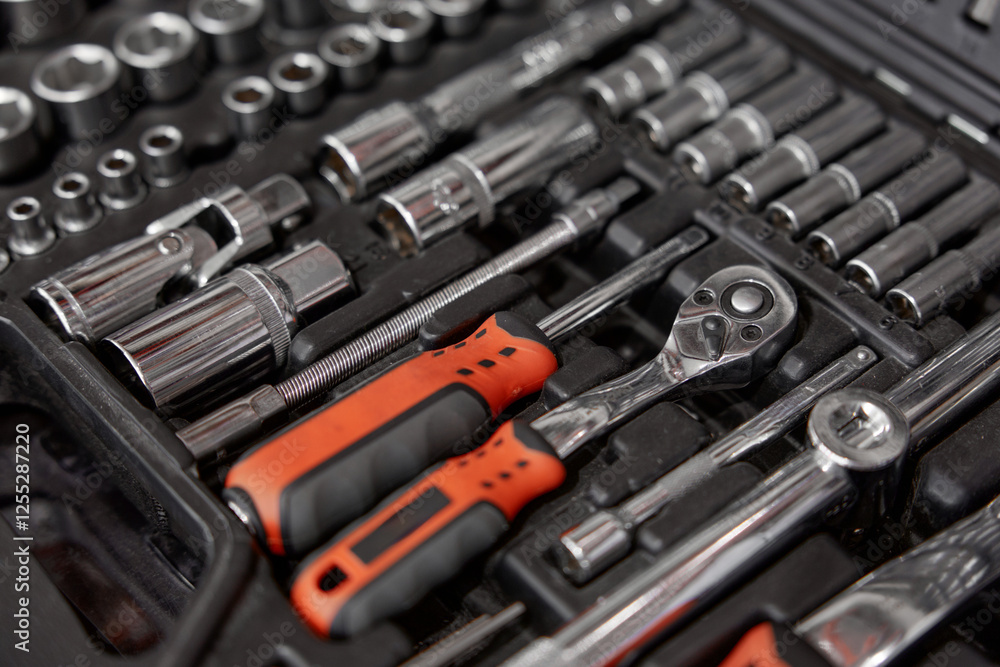 Closeup of tool box with kit of wrenches, screwdrivers and nuts for mechanic service Closeup of tool box with kit of wrenches, screwdrivers and nuts for mechanic service