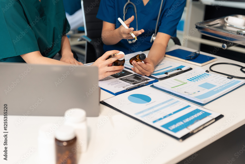 Pharmacists or doctors study information about tablets in the room. Pharmacists or doctors study information about tablets in the room.