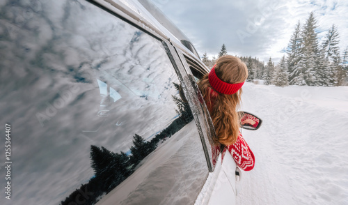 Girl Looking out Car Window during Winter Trip