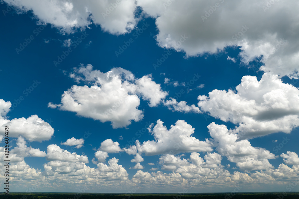 Blue sky with white summer rain clouds. Colorful summer landscape Blue sky with white summer rain clouds. Colorful summer landscape