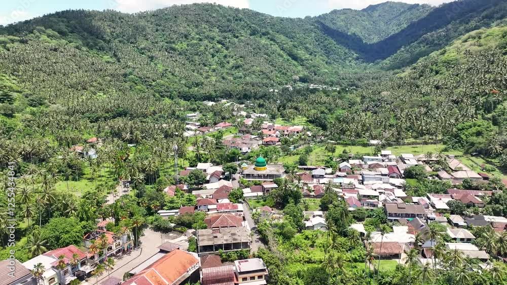 Aerial View of Town Surrounded By Mountains With Green Trees In Lombok Island, Indonesia. Aerial View of Town Surrounded By Mountains With Green Trees In Lombok Island, Indonesia.