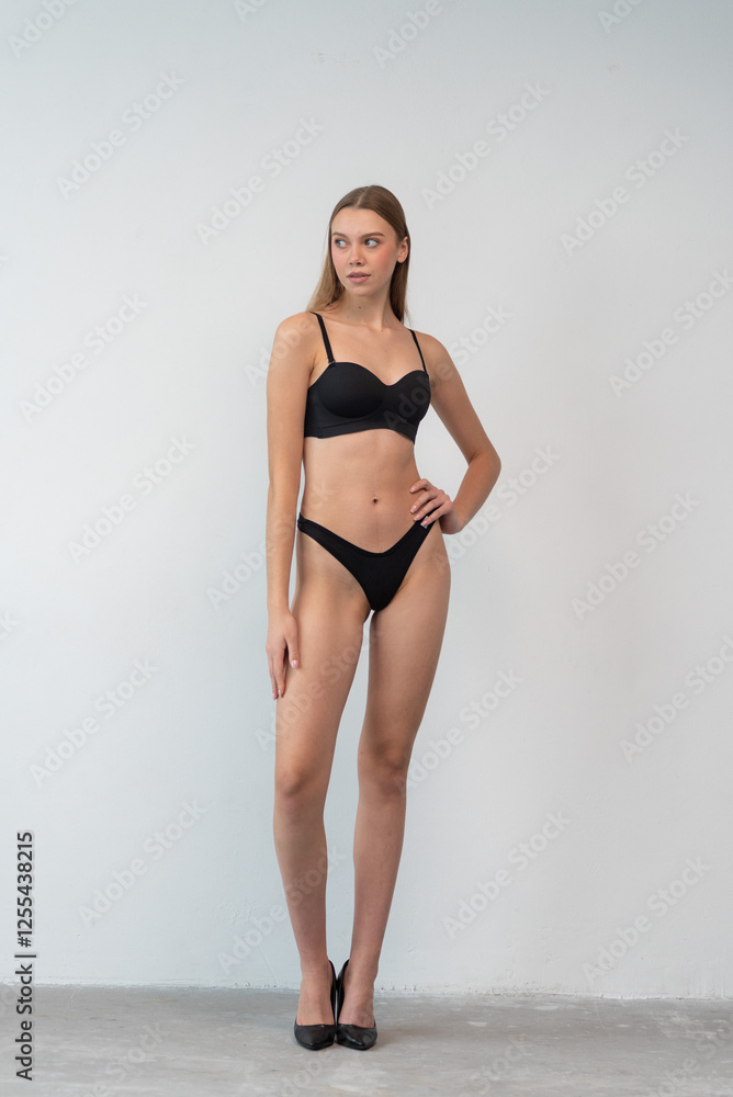 Casting snapshot of a fresh-faced model in simple black underwear, highlighting her natural features, body proportions, and confident stance. Ideal for agency scouting and professional portfolio updat Casting snapshot of a fresh-faced model in simple black underwear, highlighting her natural features, body proportions, and confident stance. Ideal for agency scouting and professional portfolio updat